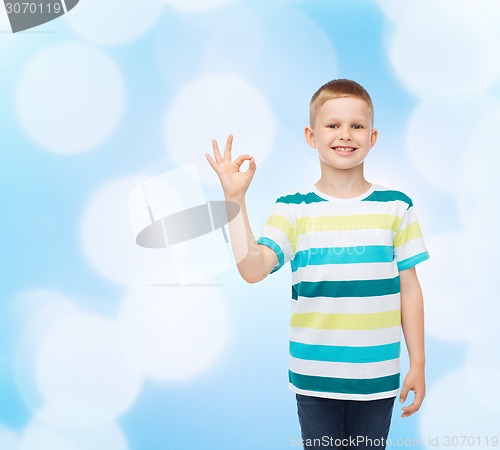 Image of little boy in casual clothes making OK gesture