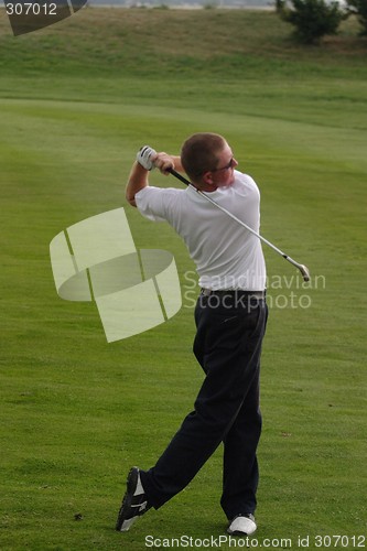 Image of Male golfer playing golf