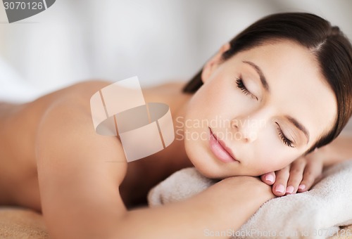 Image of beautiful woman with closed eyes in spa