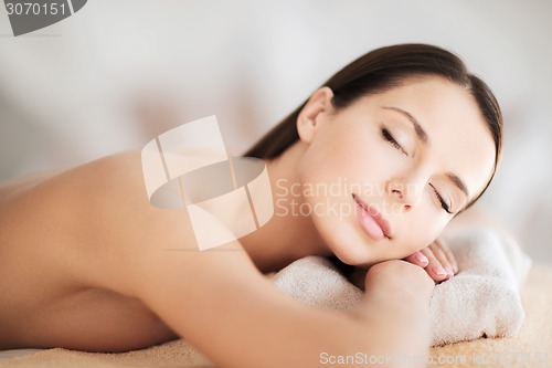 Image of beautiful woman with closed eyes in spa