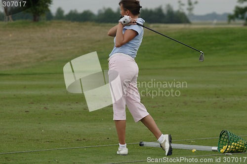 Image of Female golfer playing golf