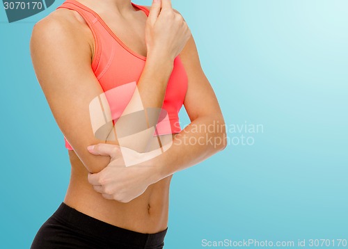 Image of sporty woman with pain in elbow