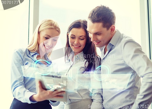 Image of business team working with tablet pc in office