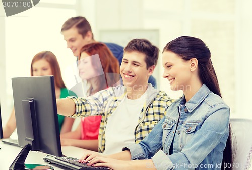 Image of female student with classmates in computer class