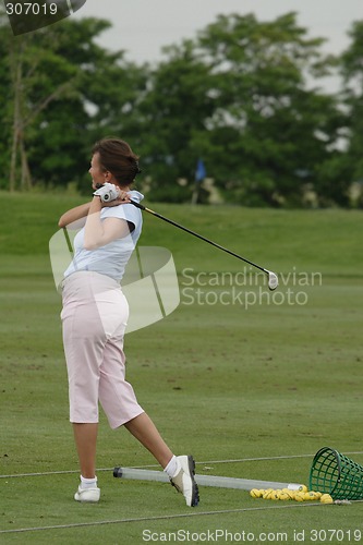 Image of Female golfer playing golf