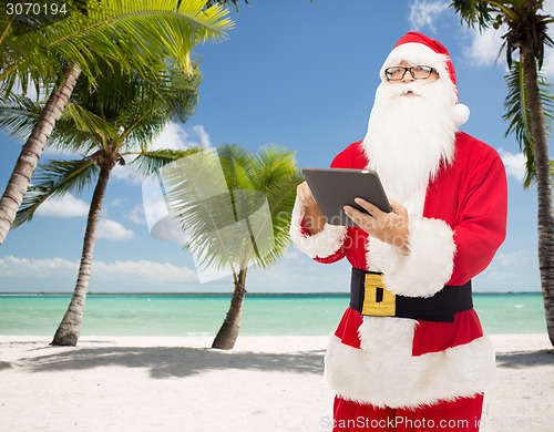 Image of man in costume of santa claus with tablet pc