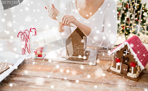 Image of close up of woman making gingerbread houses