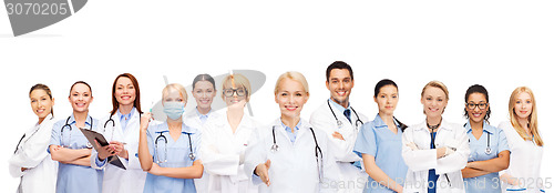 Image of smiling female doctors and nurses with stethoscope