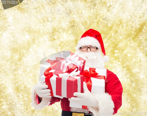 Image of man in costume of santa claus with gift boxes