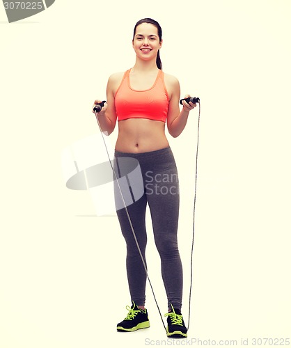 Image of sporty woman with with skipping rope