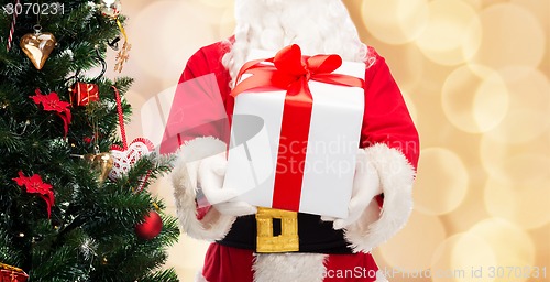 Image of man in costume of santa claus with gift box