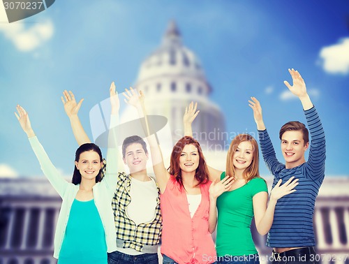 Image of group of smiling students waving hands