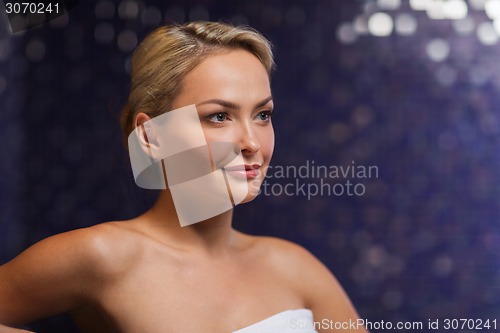 Image of close up of young woman sitting in bath towel