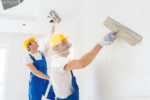 Image of group of builders with tools indoors