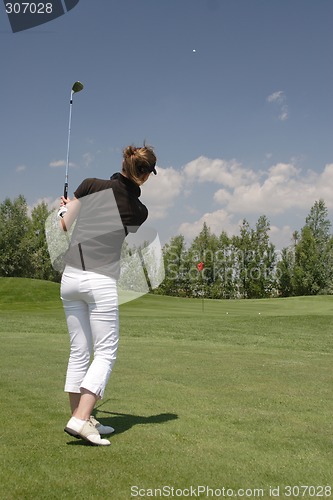 Image of Female golfer playing golf