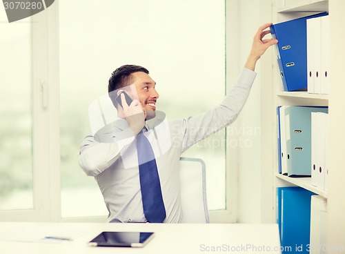 Image of businessman with smartphone and tablet pc