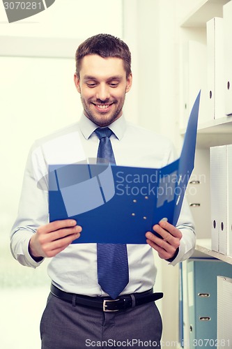 Image of businessman with folder at office