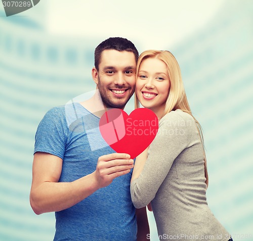 Image of smiling couple holding big red heart