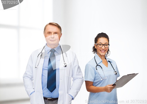 Image of smiling doctors with clipboard and stethoscopes
