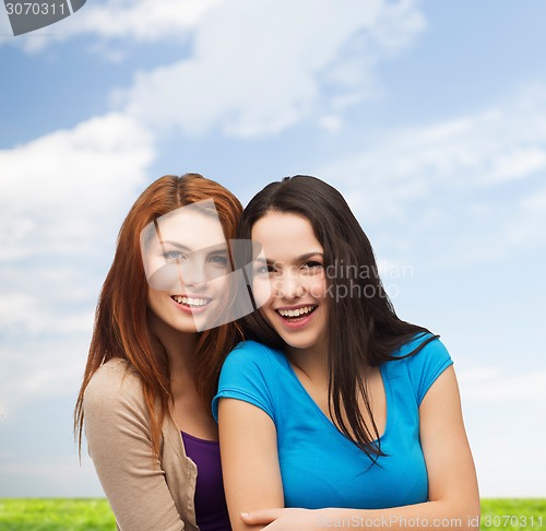 Image of smiling teenage girls hugging