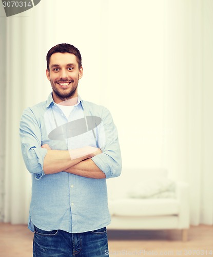 Image of smiling man with crossed arms