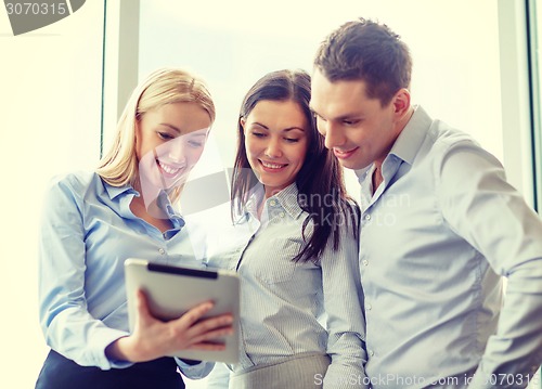 Image of business team working with tablet pc in office