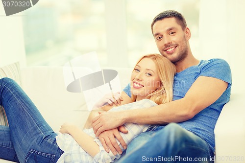 Image of smiling happy couple at home