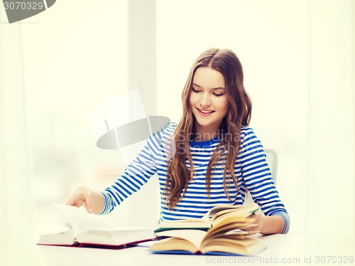 Image of happy smiling student girl with books