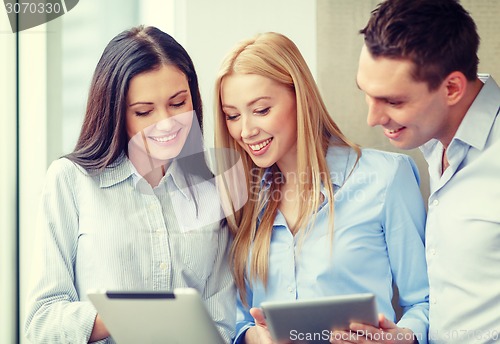 Image of business team working with tablet pcs in office