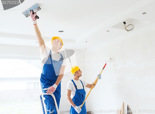 Image of group of builders with tools indoors