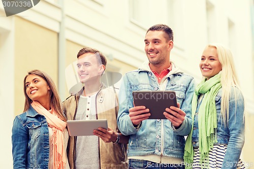 Image of group of smiling friends with tablet pc computers