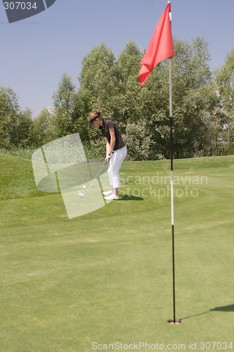 Image of Female golfer playing golf