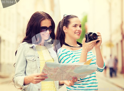 Image of smiling teenage girls with map