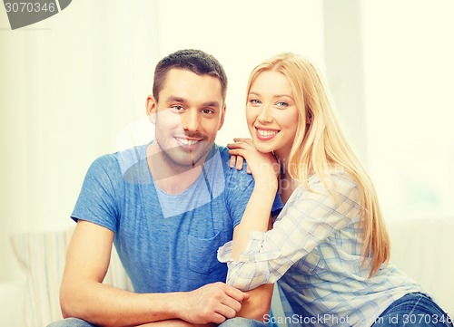 Image of smiling happy couple at home
