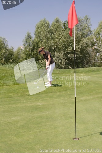 Image of Female golfer playing golf