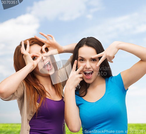 Image of smiling teenage girls having fun