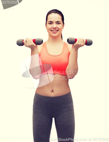 Image of young sporty woman with light dumbbells