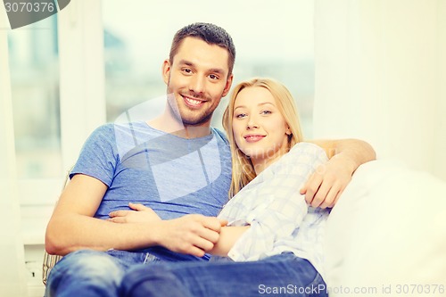 Image of smiling happy couple at home