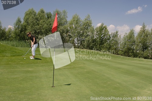 Image of Female golfer playing golf