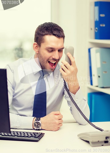 Image of screaming businessman or student with computer