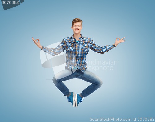 Image of smiling young man jumping in air