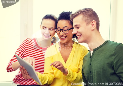 Image of smiling students with tablet pc at school