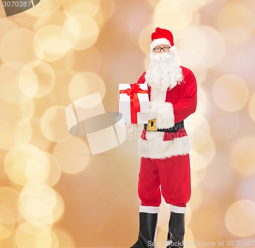 Image of man in costume of santa claus with gift box