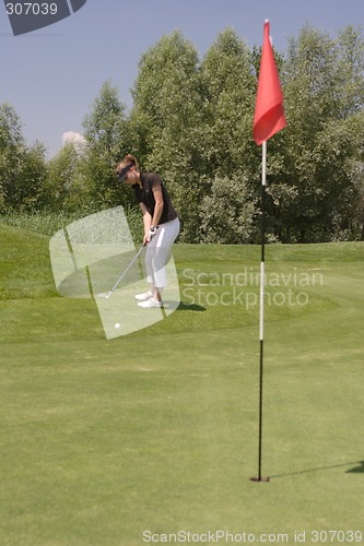 Image of Female golfer playing golf