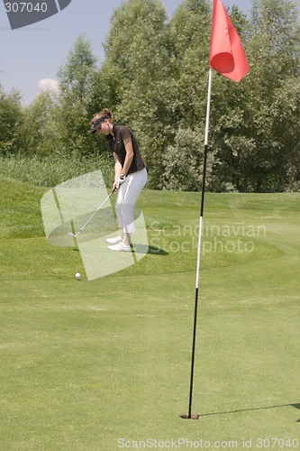 Image of Female golfer playing golf