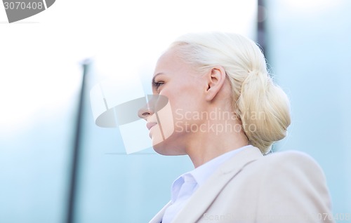 Image of young businesswoman over office building