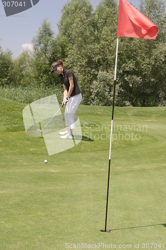 Image of Female golfer playing golf