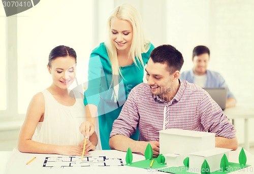 Image of smiling architects working in office