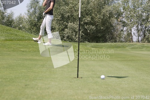 Image of Female golfer playing golf