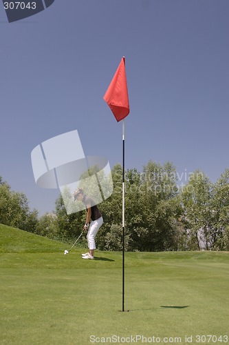 Image of Female golfer playing golf